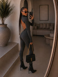 Tuta in lycra grigia schiena aperta e catenina - R.a. Boutique