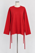 Maglia rossa oversize con taglio sfilettato e lacci laterali