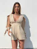 Tutina beige con fiocchetti - R.a. Boutique 