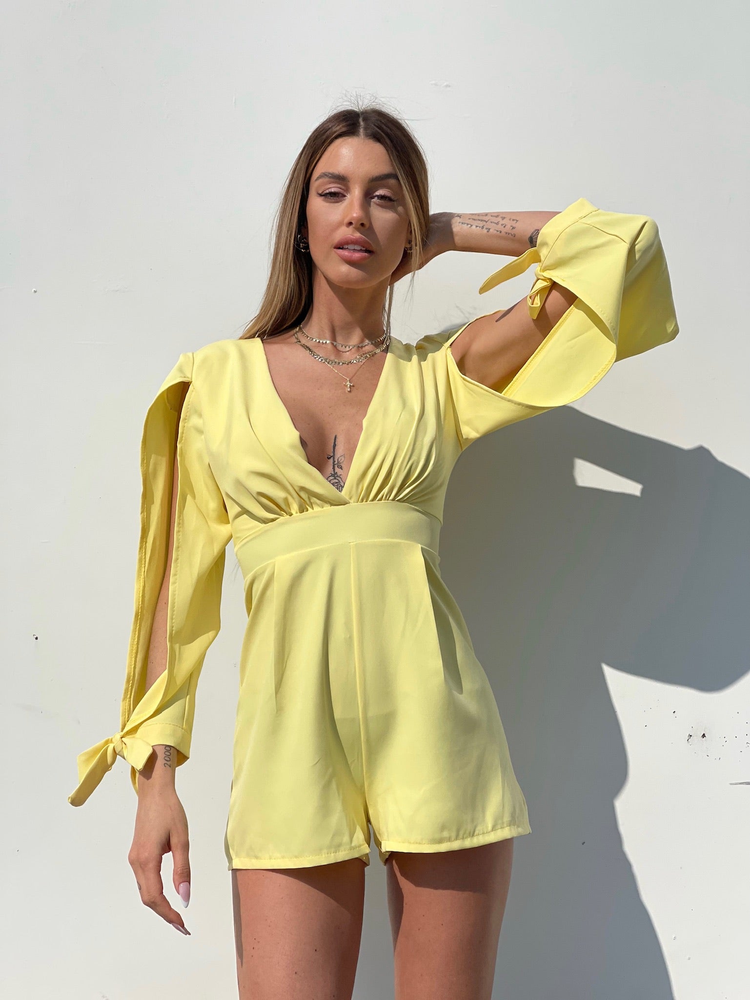 Tutina gialla con fiocchetti - R.a. Boutique 